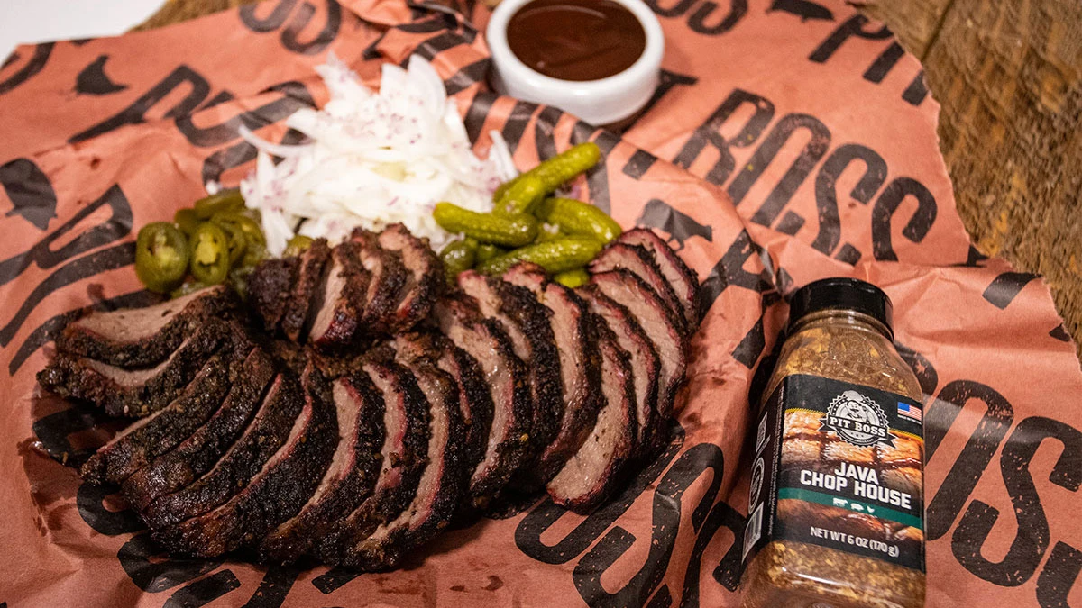 Brisket Slices with Pickles, Onions and Jalapenos next to a Pit Boss Java Chop House Rub Bottle
