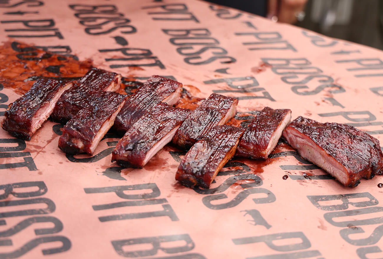 smoked tailgating ribs cooked on a pit boss wood pellet grill. sliced and plated on pit boss butcher paper