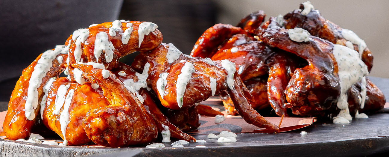 homemade fresh ranch dip and dressing, drizzled on crispy bbq wings