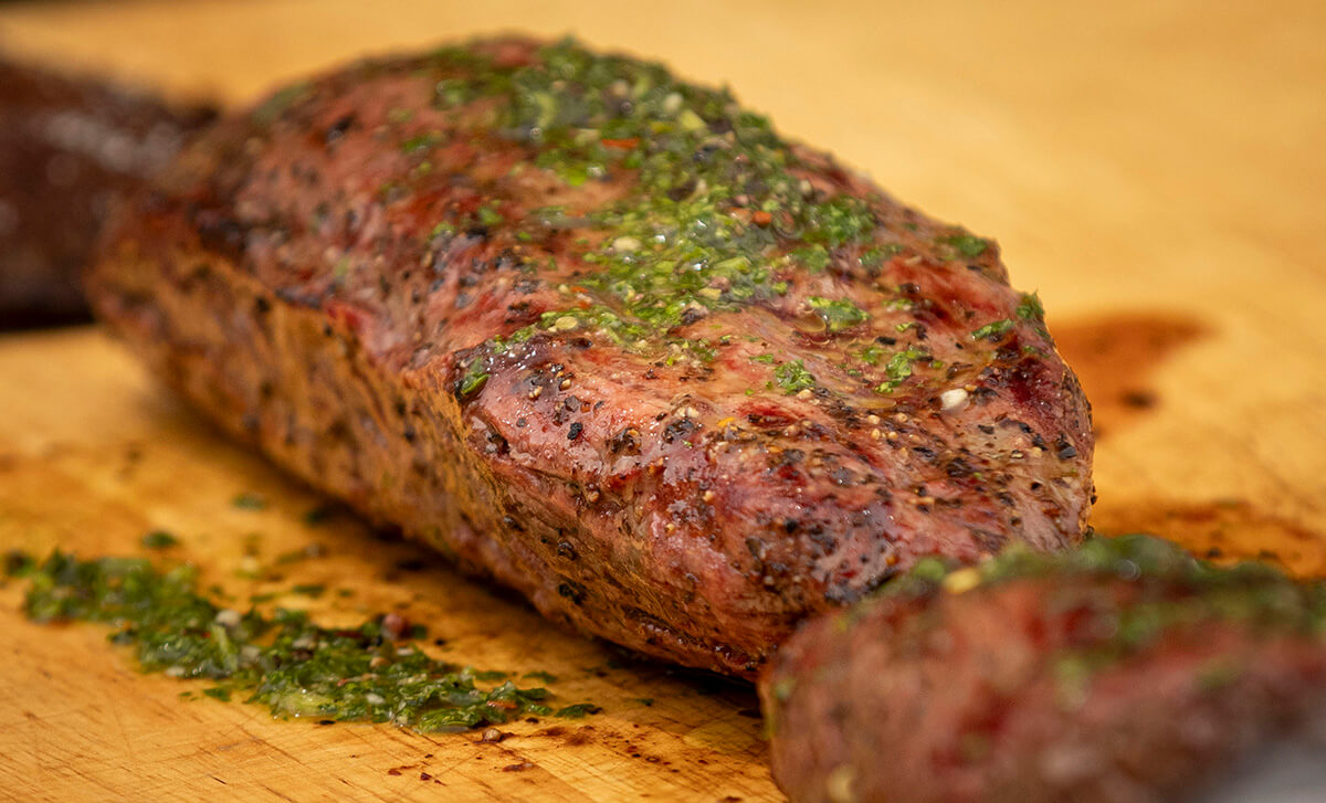 homemade chimichurri sauce spread on grilled steak