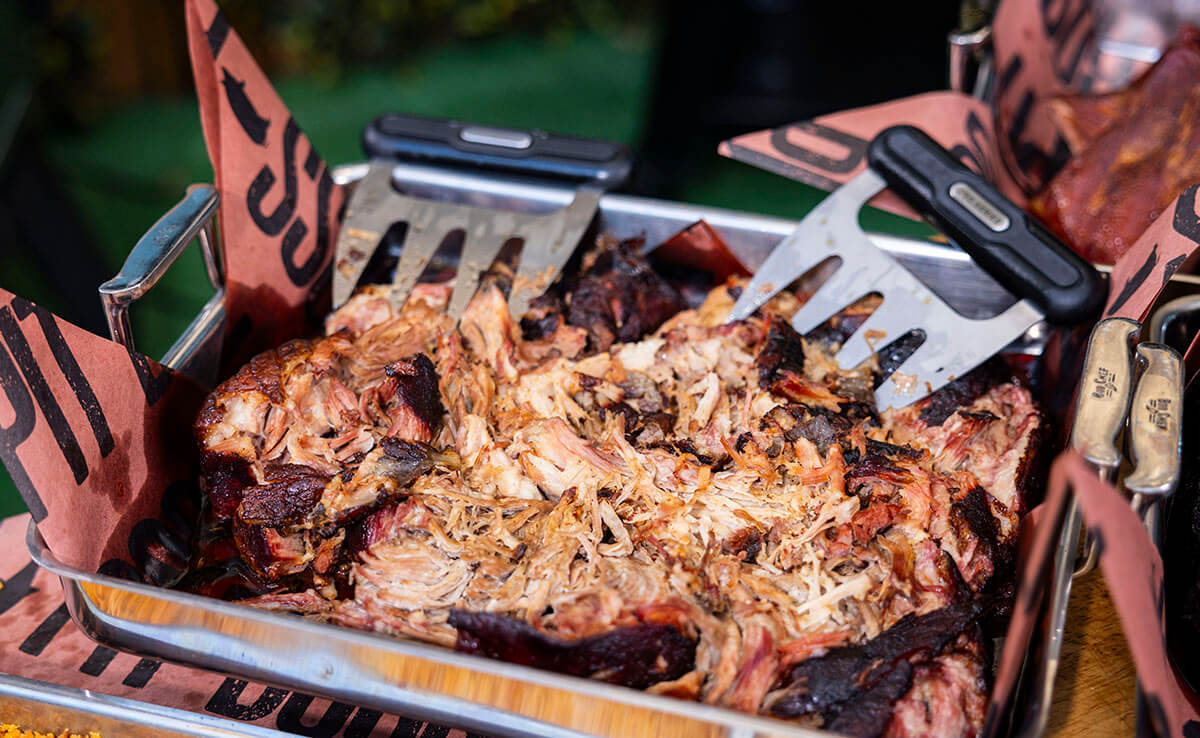 classic smoked pulled pork recipe cooked on a pit boss wood pellet grill. shredded in tray with pit boss meat claws and butcher wrap