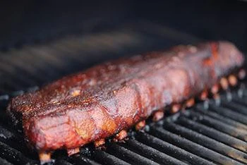 up close of cooked ribs on rack of pit boss grill