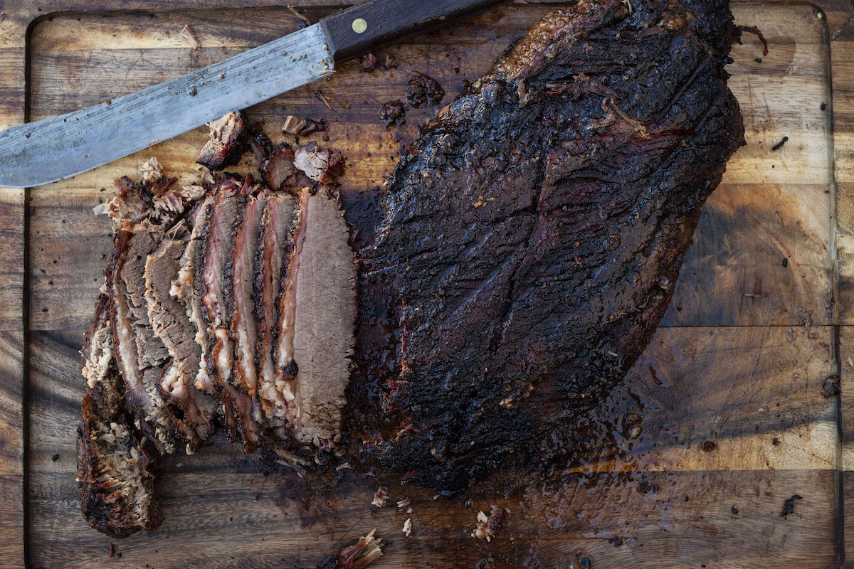 Tasty looking Easy Beef Brisket sliced on wooden cutting board