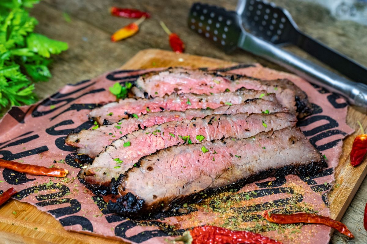 tasty looking Grilled Tri Tip with herbs on top of butcher paper