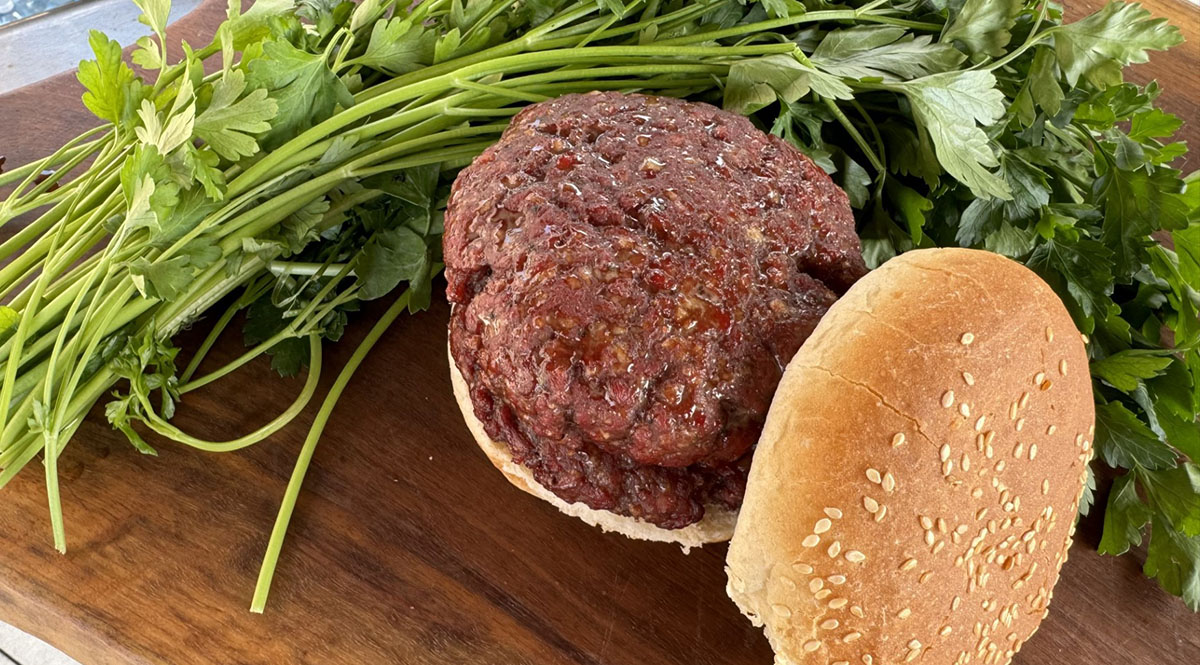 homemade smoked and grilled brisket burger patties summer recipes with hamburger bun and fresh herbs