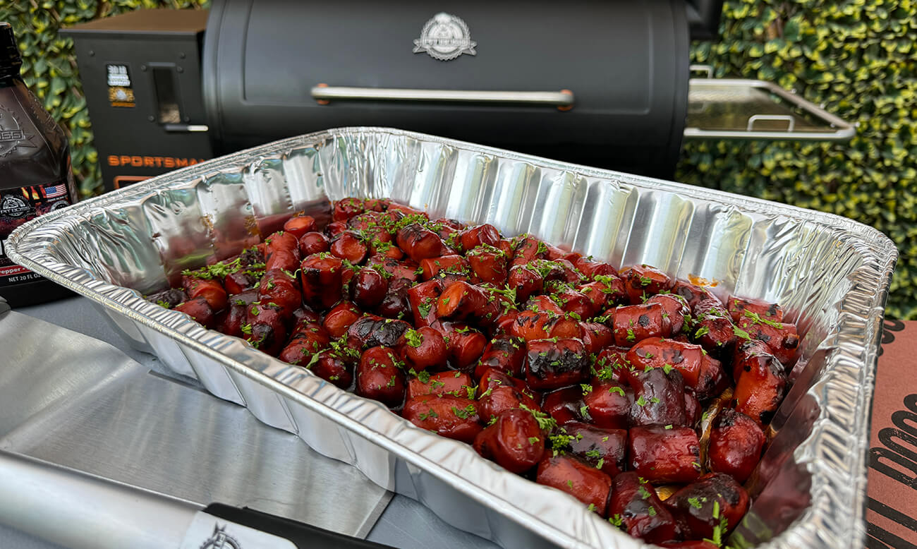 smoked hot dog burnt ends cooked on a pit boss wood pellet grill in aluminum pan