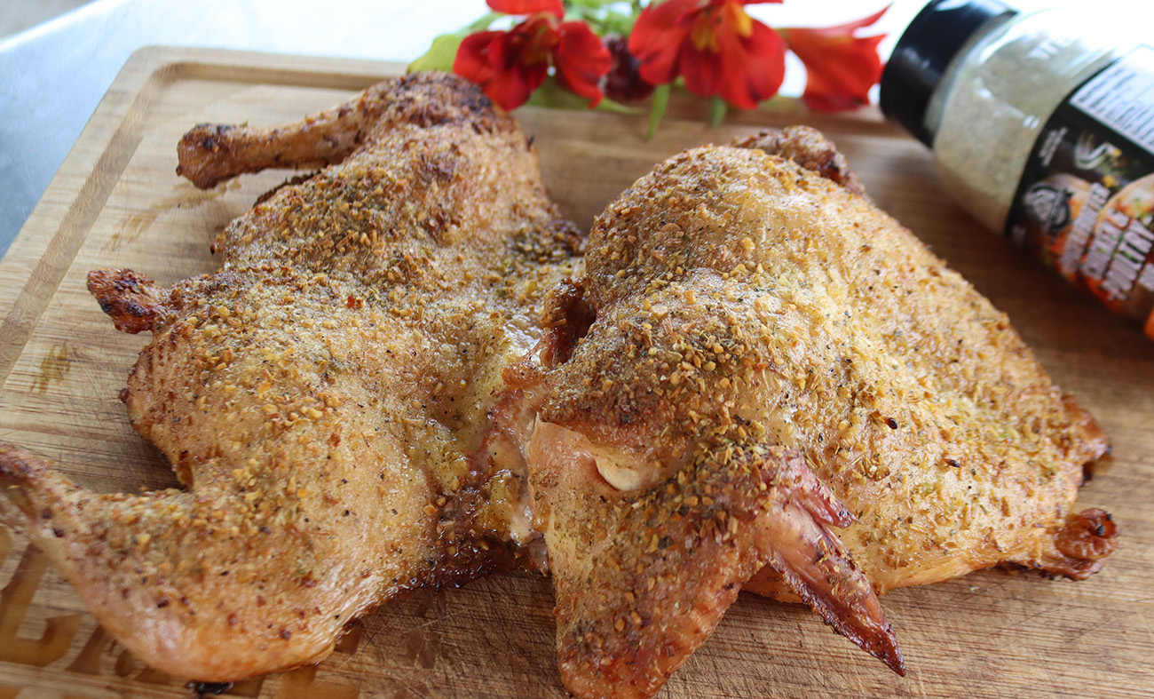 smoked and seasoned whole chicken cooked on a pit boss wood pellet grill