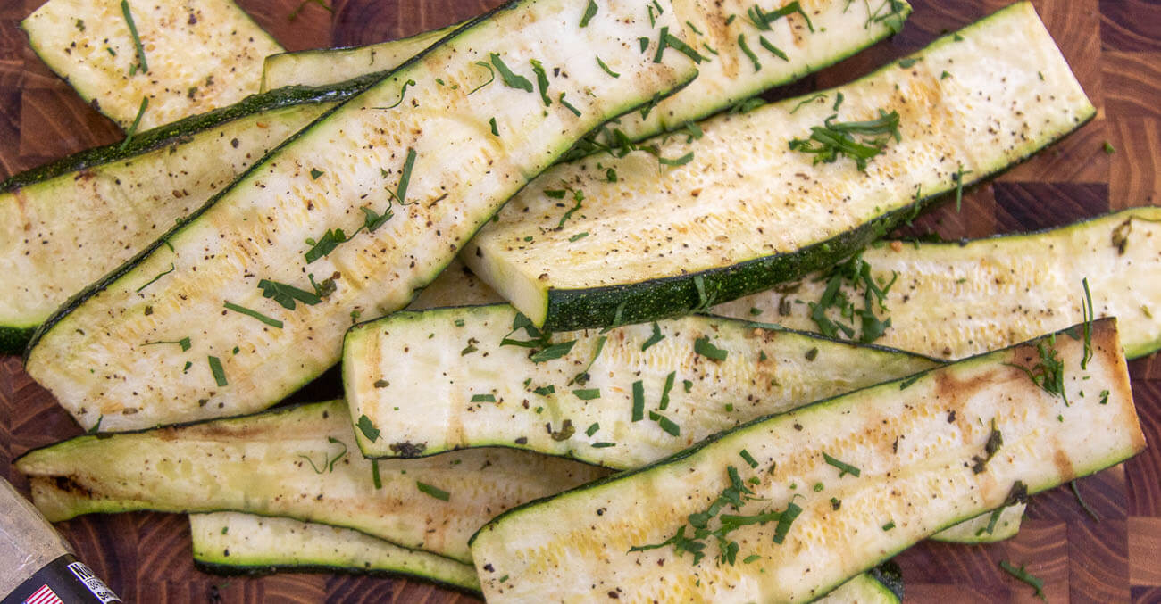 Grilled zucchini and Pit Bos GSP Rub on wooden cutting board