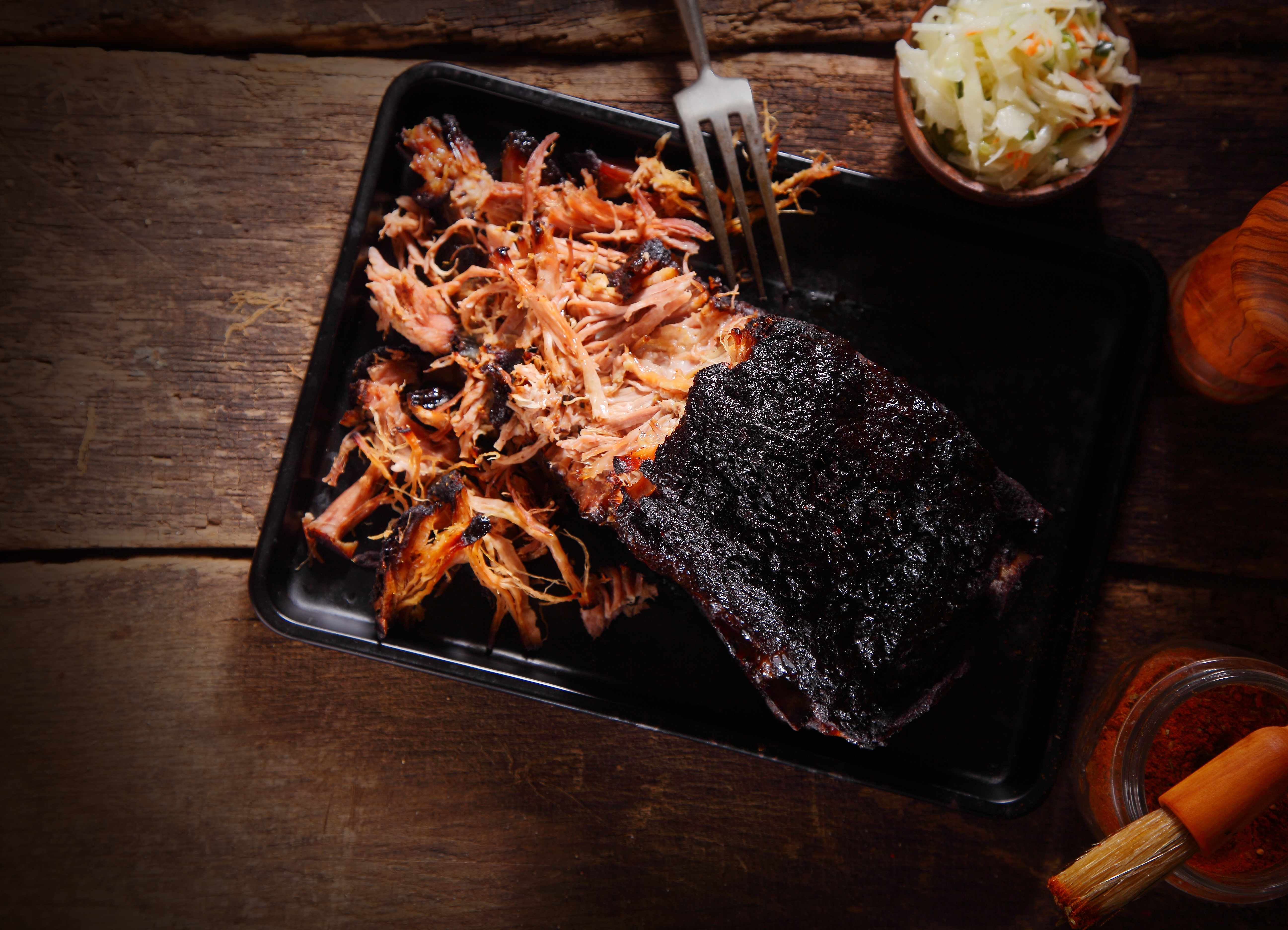 Juicy pulled pork on tray on wooden table pit boss grills hardwood pellets and smokers