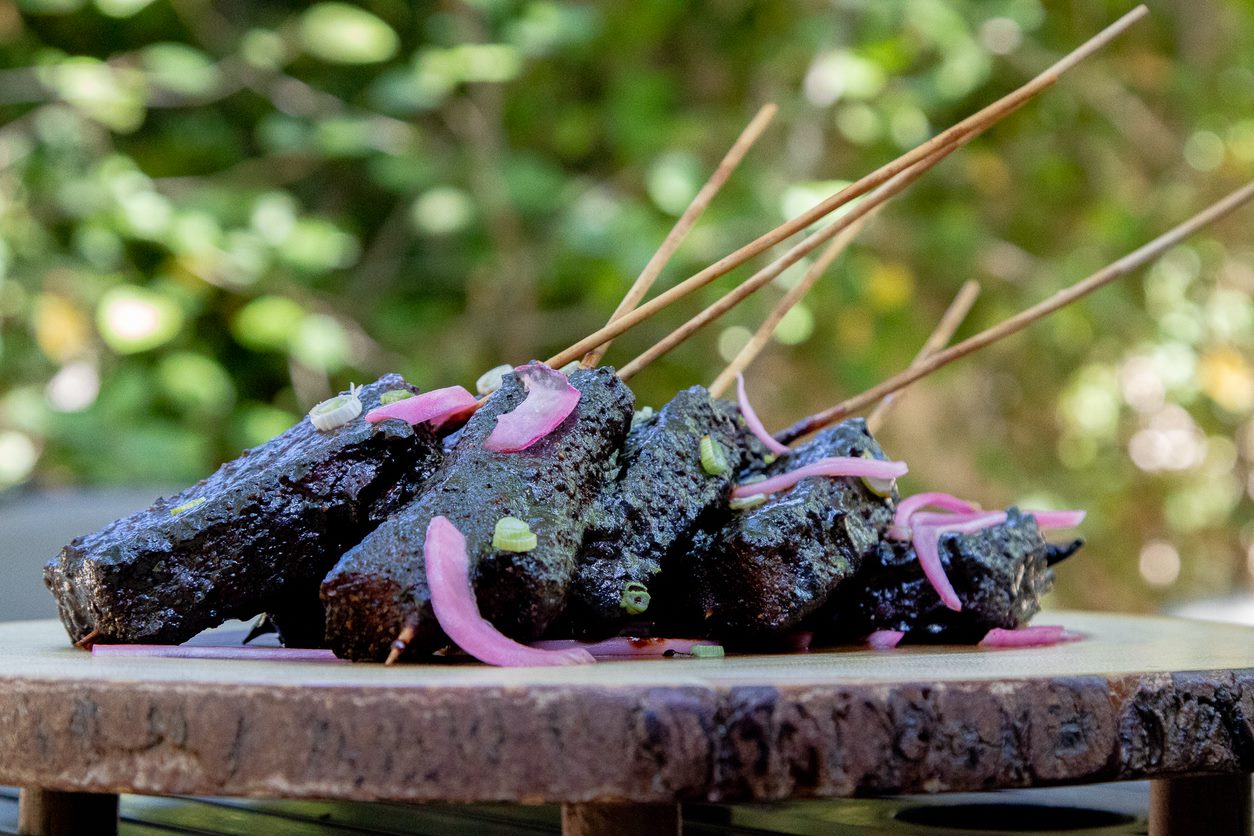 smoked and saucy pork belly lollipops on wooden skewer. smoked on a pit boss hardwood pellet smoker