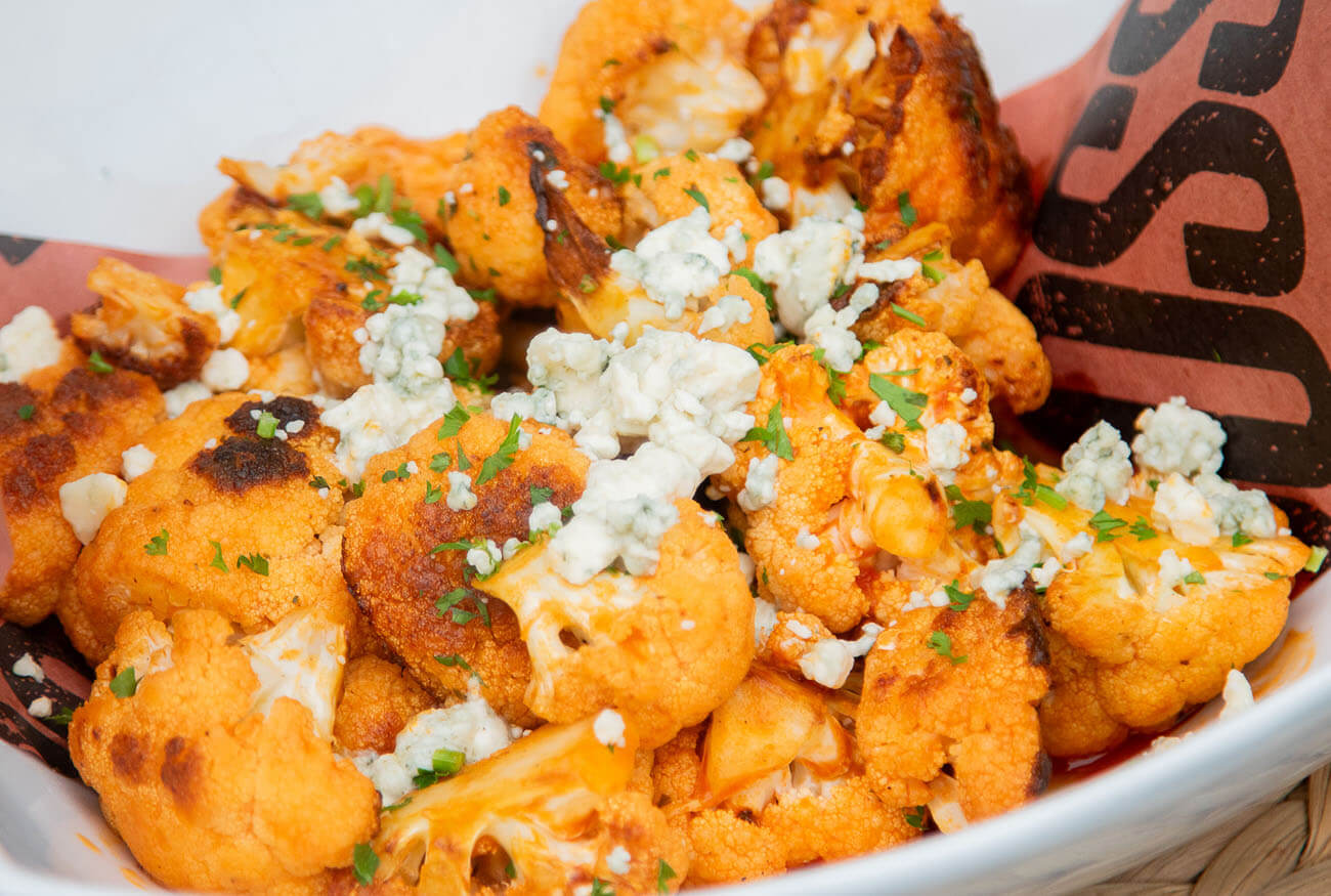 grilled and smoked roasted buffalo cauliflower topped with blue cheese crumbles