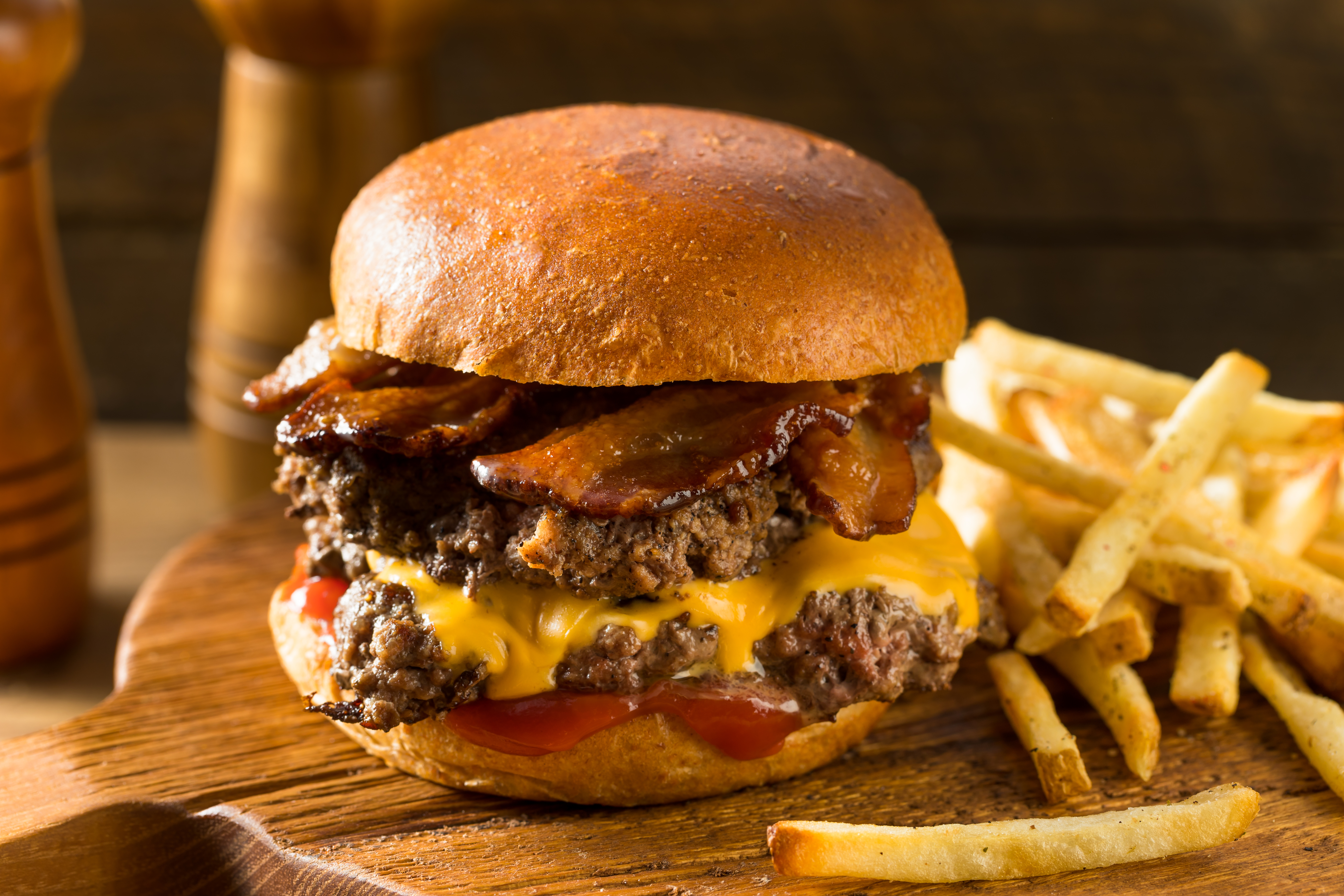 Cheese burger with bacon and fries on the side