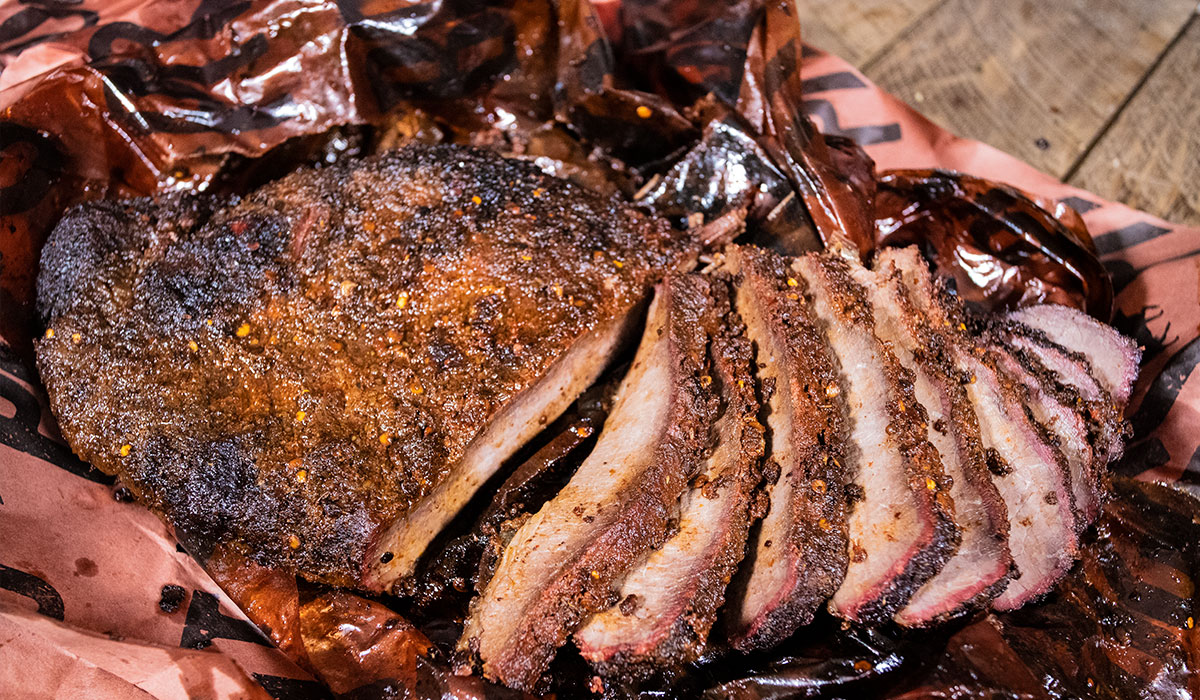 Tasty looking brisket slices with chili pepper rub on butcher paper