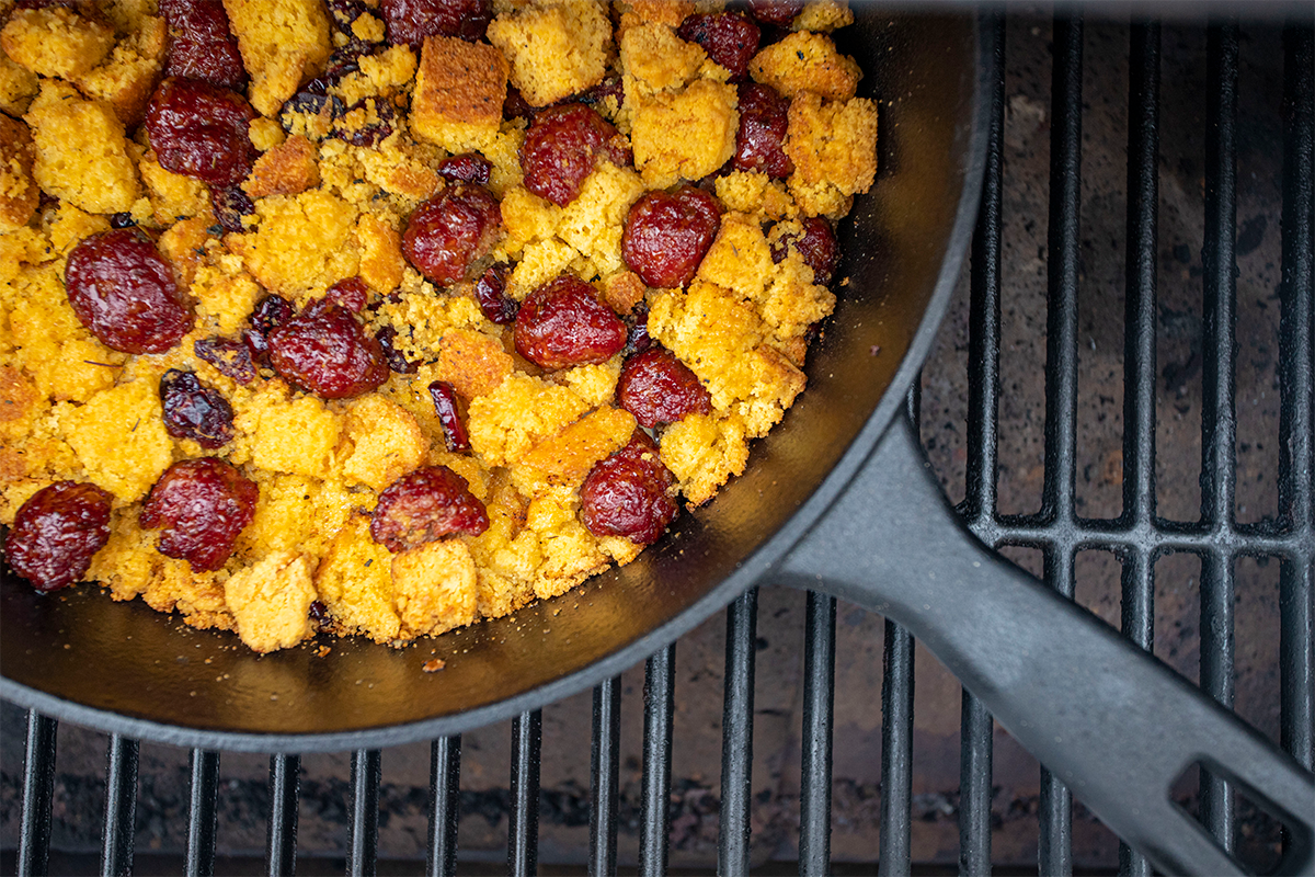 corn bread stuffing in cast iron skillet on pit boss grill rack