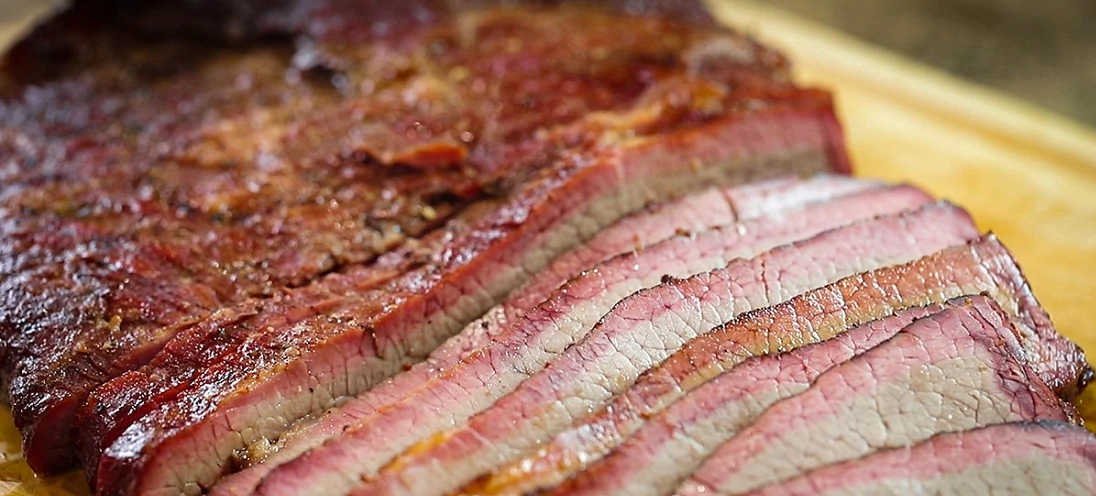 Up close of brisket where half of it is sliced