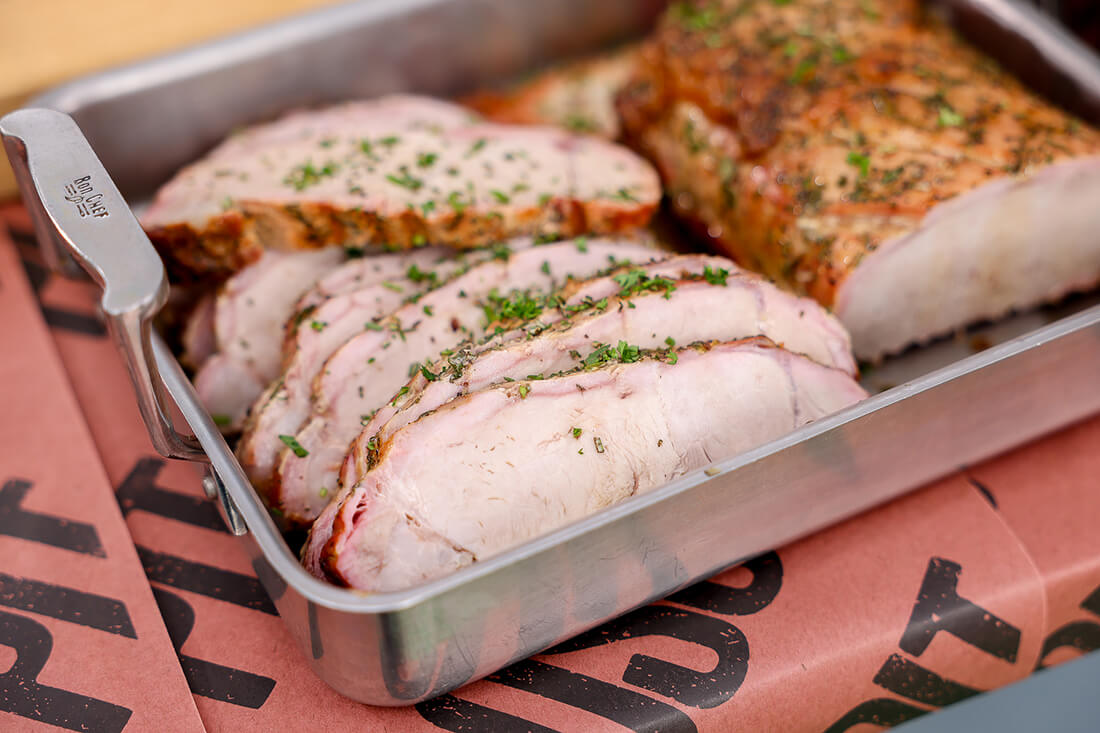 grilled pork loin recipe, topped with rosemary served in tray with pit boss butcher paper