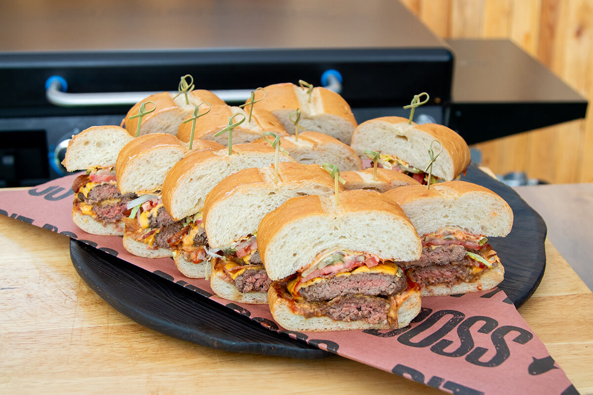 shareable party burger cooked on a pit boss gas flat top griddle and sliced
