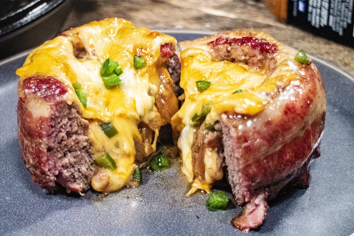 tasty looking Barbecue Stuffed Burger cut in half with cheese oozing out